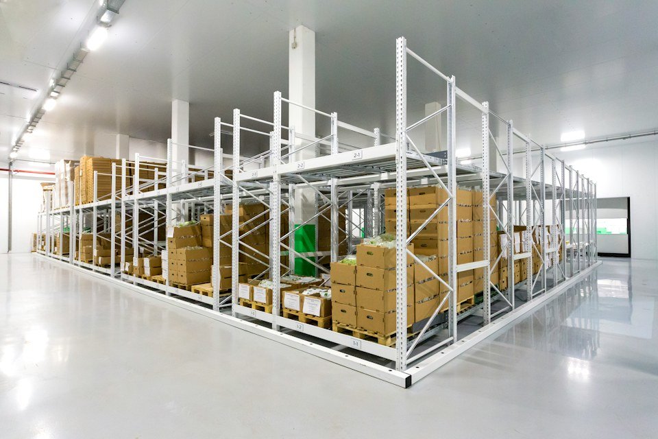 Warehouse storage racks holding boxed inventory, representative of commercial asset consignments